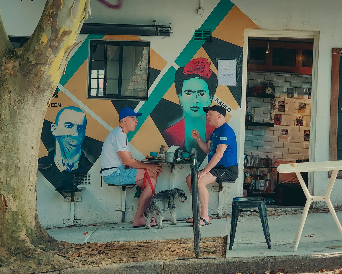 Regulars and their dog outside the mural wall
