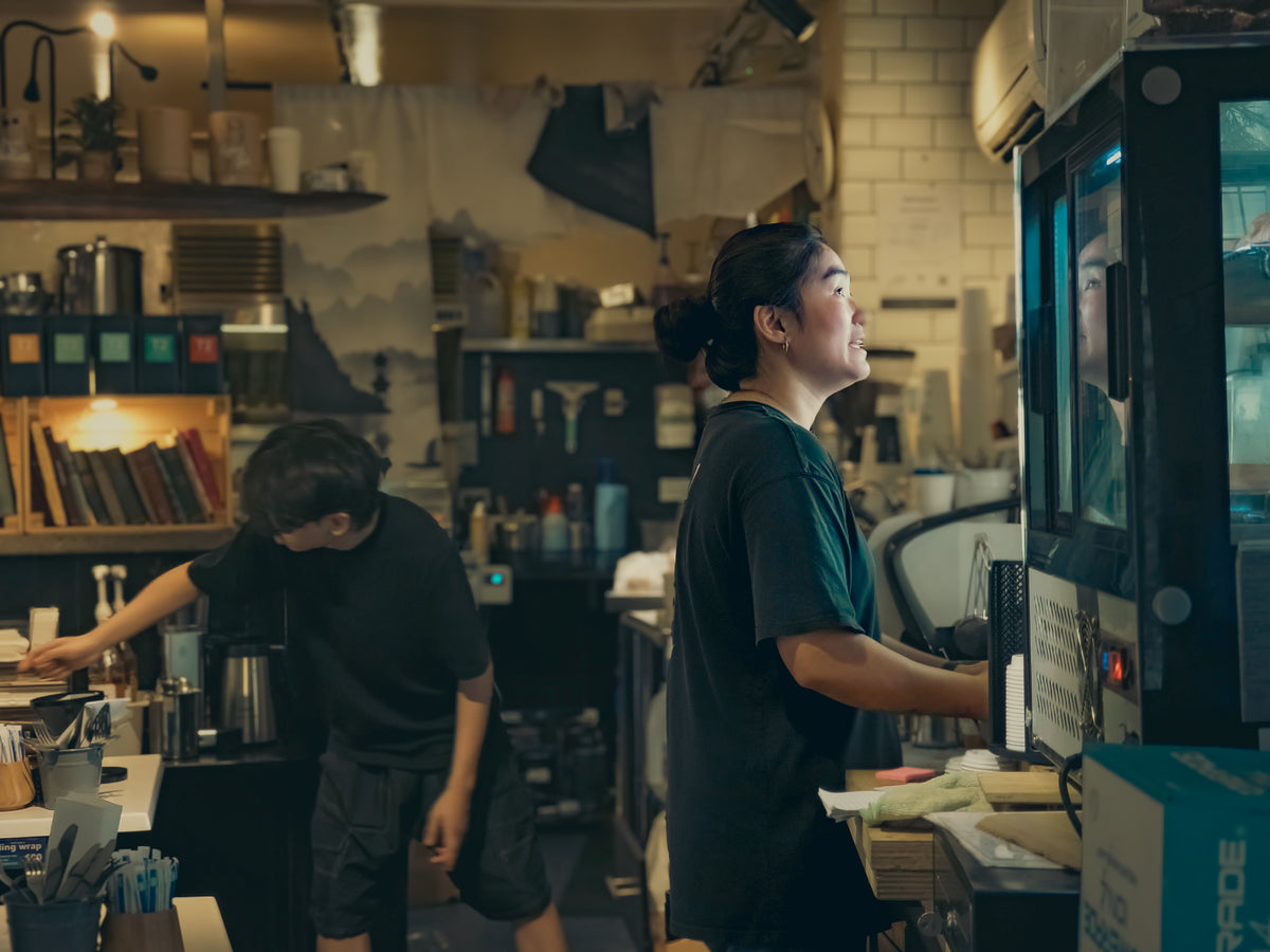 Two baristas behind the counter
