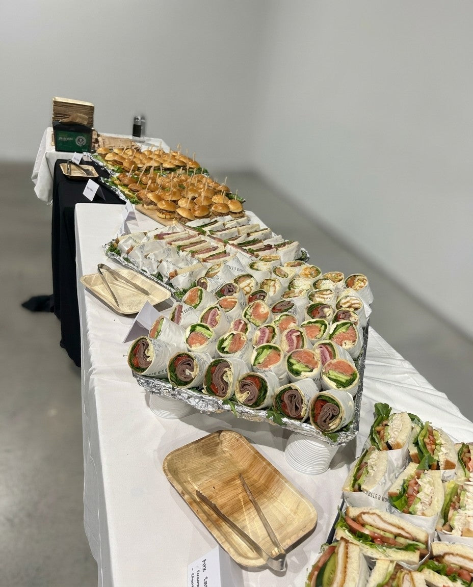 A full catering spread of wraps, sandwiches and sliders